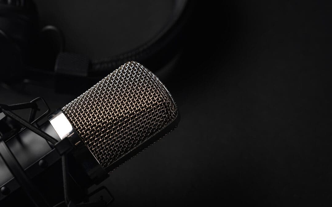 A microphone and headphones representing a podcast studio